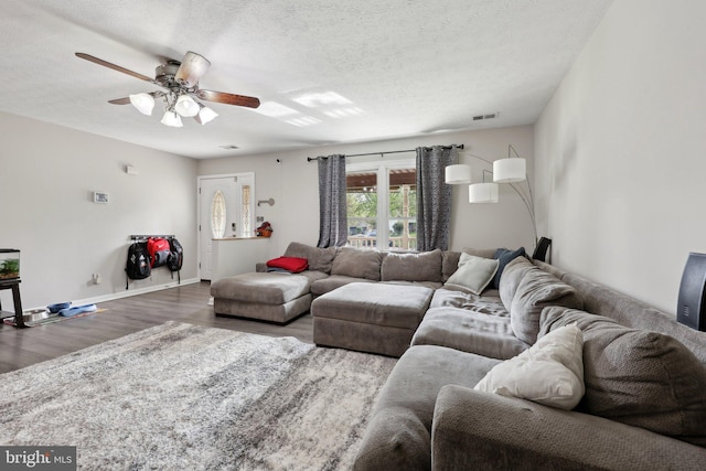 7303 Westwind Ct, Bowie, MD 20715 - living room featuring a ceiling fan, visible vents, baseboards, a textured ceiling, and wood finished floors