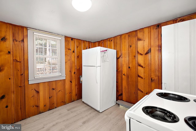 10 34th St, Ocean City, MD 21842 - kitchen with wooden walls, brown cabinetry, light wood finished floors, and white appliances