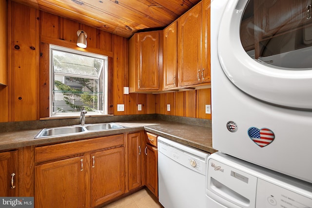10 34th St, Ocean City, MD 21842 - kitchen featuring brown cabinets, wood walls, dishwasher, and a sink