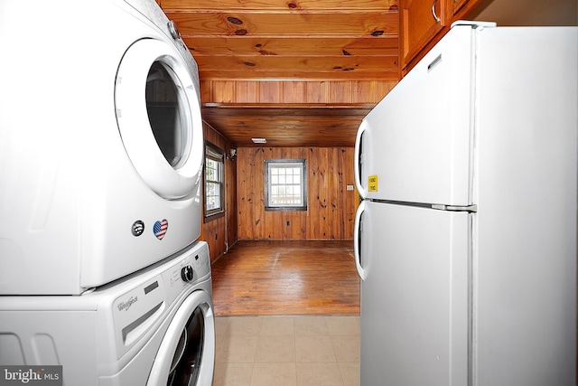 10 34th St, Ocean City, MD 21842 - laundry room with laundry area, light tile patterned floors, wooden ceiling, wood walls, and stacked washer and clothes dryer