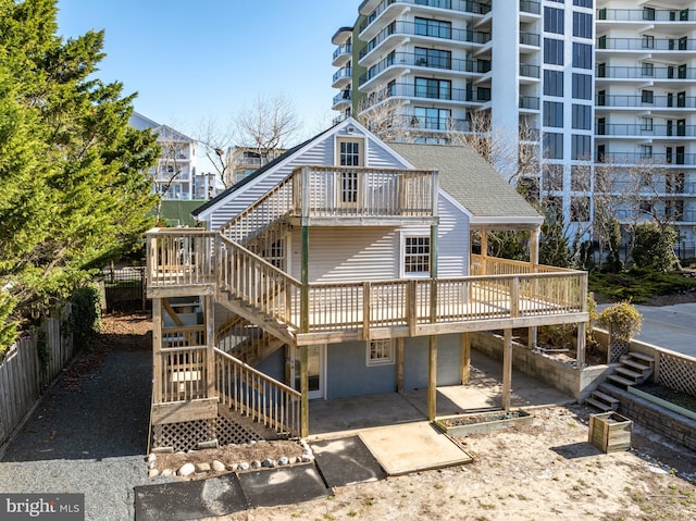 10 34th St, Ocean City, MD 21842 - rear view of house with a patio area, fence, stairway, and a wooden deck