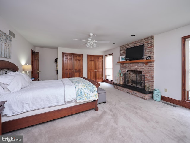 110 Clay Ridge Rd, Ottsville, PA 18942 - carpeted bedroom with a fireplace, two closets, and ceiling fan