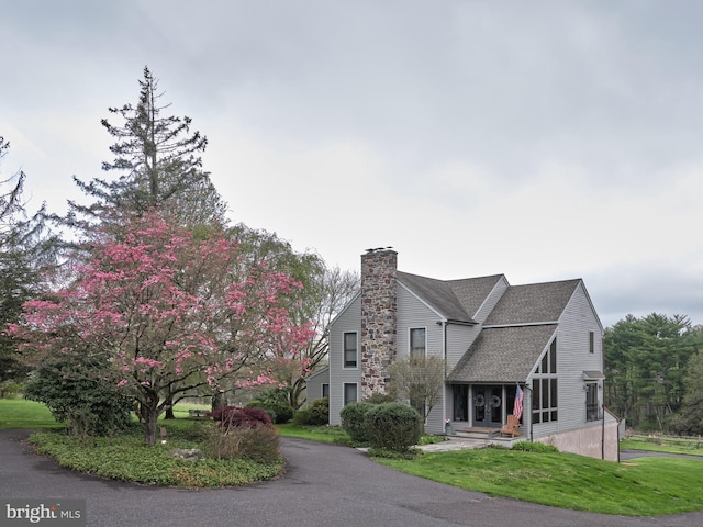 110 Clay Ridge Rd, Ottsville, PA 18942 - view of front of property featuring a chimney, roof with shingles, and a front lawn