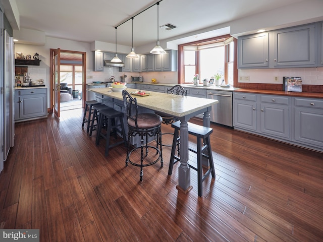 110 Clay Ridge Rd, Ottsville, PA 18942 - kitchen with gray cabinets, stainless steel dishwasher, a breakfast bar area, and healthy amount of natural light
