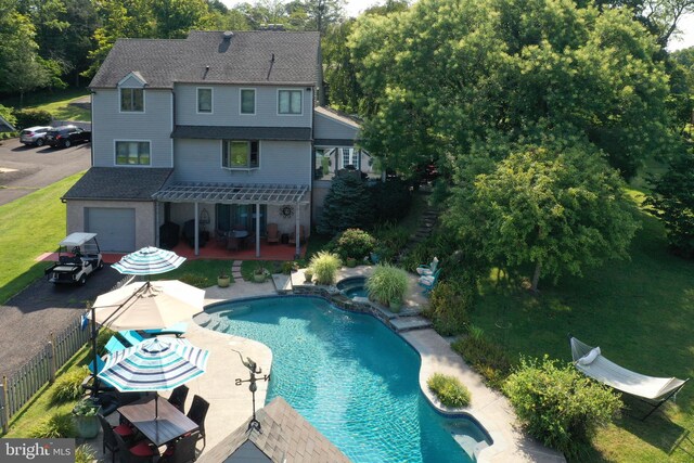 110 Clay Ridge Rd, Ottsville, PA 18942 - rear view of house with a patio, a pool with connected hot tub, a pergola, a shingled roof, and view of scattered trees