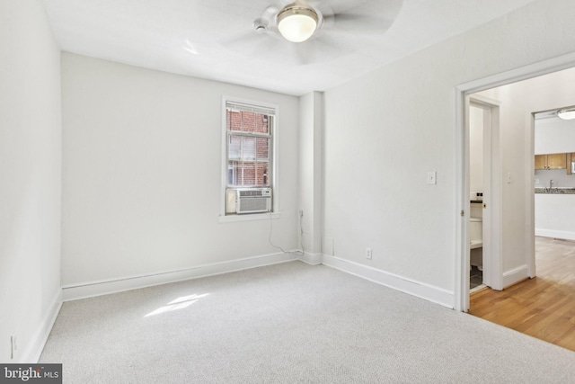 unfurnished bedroom with ceiling fan, cooling unit, baseboards, and carpet floors