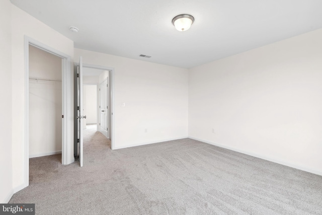 unfurnished bedroom featuring a closet, baseboards, visible vents, and carpet floors