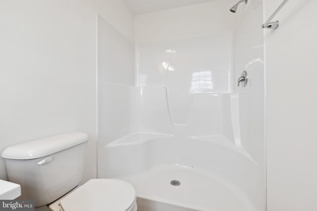 bathroom with toilet and a shower
