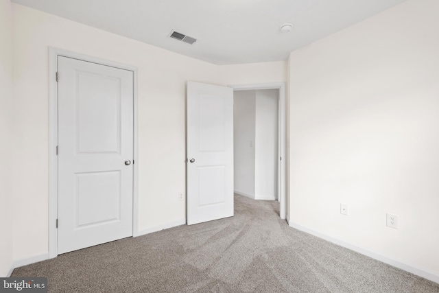 unfurnished bedroom with visible vents, baseboards, and carpet floors