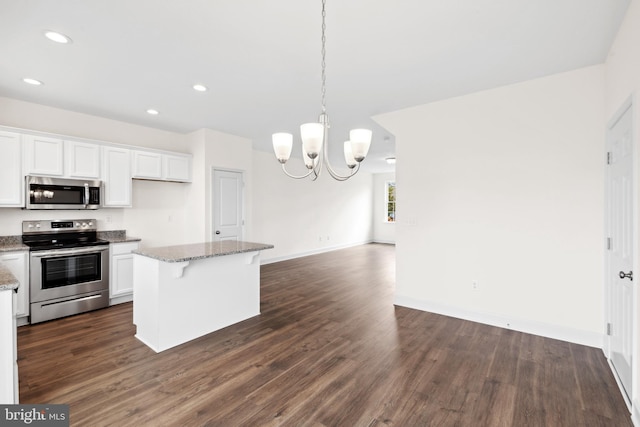 kitchen with open floor plan, dark wood-style floors, white cabinets, and stainless steel appliances
