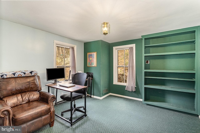carpeted home office featuring baseboards and plenty of natural light