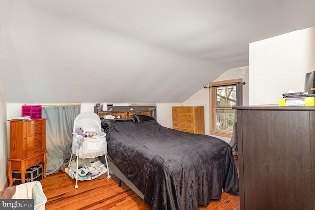 bedroom featuring vaulted ceiling and wood finished floors