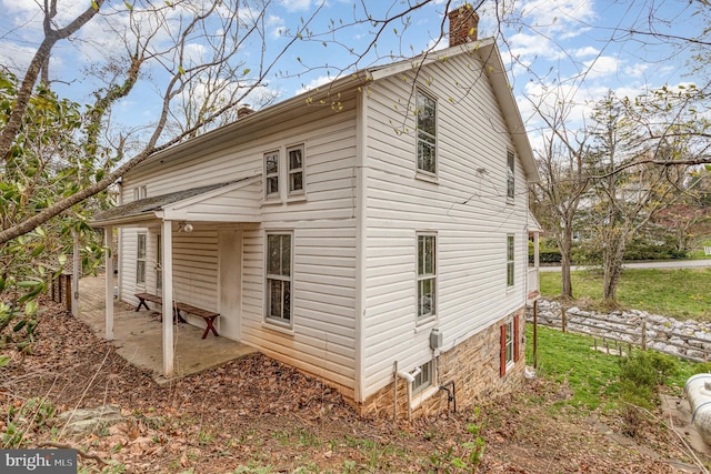 view of home's exterior featuring a chimney