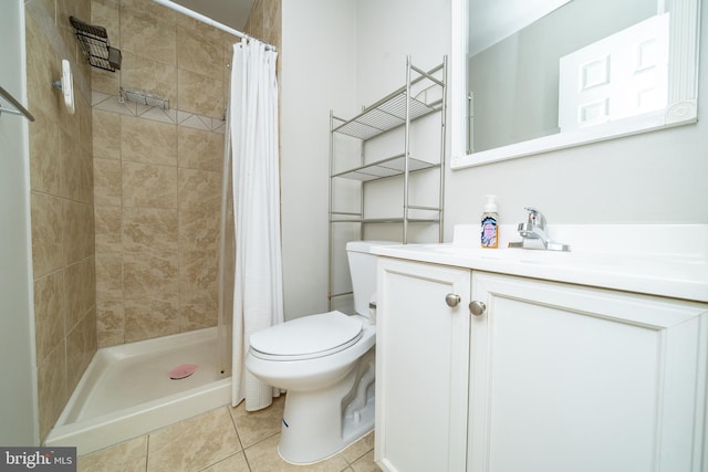 full bathroom featuring vanity, tile patterned flooring, a stall shower, and toilet