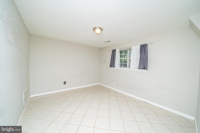 unfurnished room with baseboards and visible vents