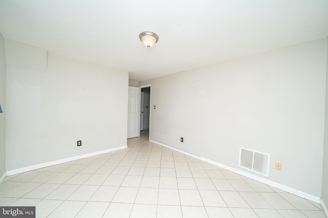 unfurnished room with baseboards and visible vents