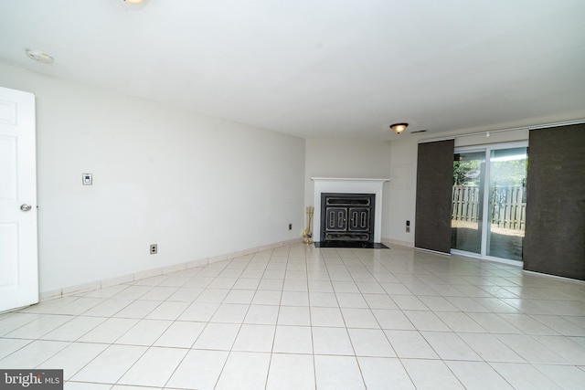unfurnished living room with a fireplace with flush hearth and light tile patterned floors