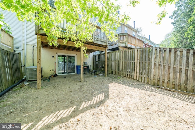 view of yard featuring a deck, cooling unit, and a fenced backyard
