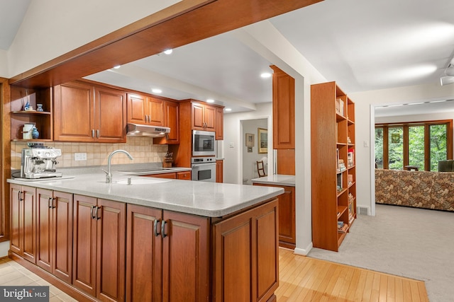 552 Brookwood Rd, Wayne, PA 19087 - kitchen with open shelves, under cabinet range hood, appliances with stainless steel finishes, brown cabinetry, and decorative backsplash