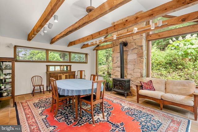 552 Brookwood Rd, Wayne, PA 19087 - tiled dining space featuring a wood stove, beam ceiling, and plenty of natural light