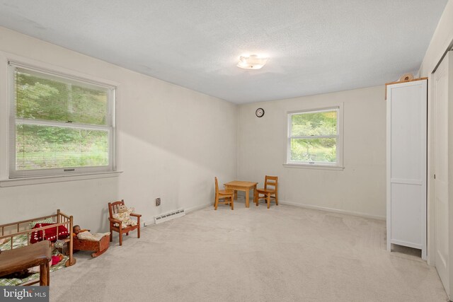 552 Brookwood Rd, Wayne, PA 19087 - playroom featuring carpet flooring, a baseboard radiator, and a textured ceiling
