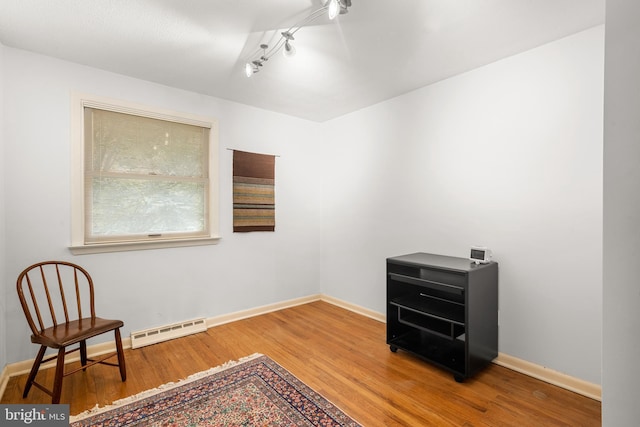 552 Brookwood Rd, Wayne, PA 19087 - unfurnished room featuring baseboard heating, wood finished floors, and track lighting