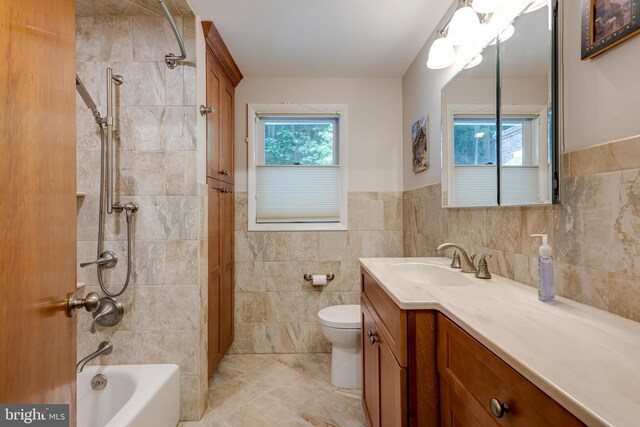 552 Brookwood Rd, Wayne, PA 19087 - full bathroom with tile walls, vanity,  shower combination, a wainscoted wall, and tile patterned flooring