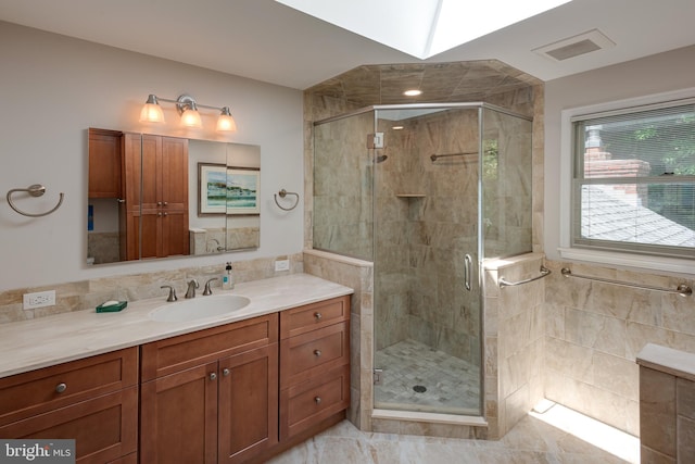 552 Brookwood Rd, Wayne, PA 19087 - full bathroom featuring vanity, a shower stall, and tile walls
