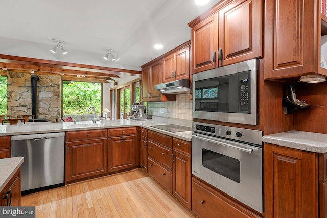 552 Brookwood Rd, Wayne, PA 19087 - kitchen with appliances with stainless steel finishes, light wood finished floors, brown cabinets, and light countertops