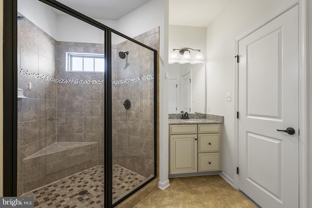 full bathroom with vanity, tile patterned flooring, and a shower stall