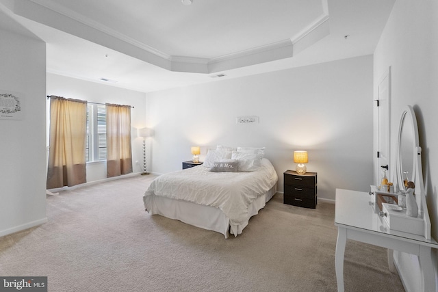 carpeted bedroom with a raised ceiling, ornamental molding, baseboards, and visible vents