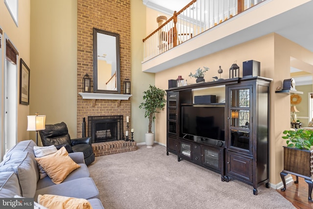 109 Aulee Ct, Winchester, VA 22602 - carpeted living room featuring a brick fireplace, a high ceiling, and baseboards