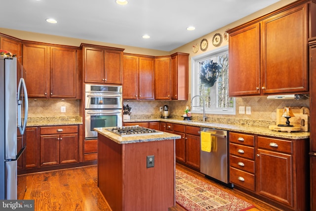 109 Aulee Ct, Winchester, VA 22602 - kitchen with light stone counters, a sink, dark wood-type flooring, tasteful backsplash, and appliances with stainless steel finishes