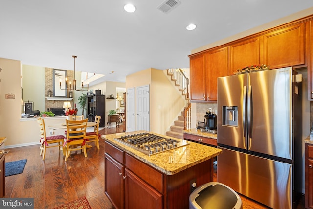 109 Aulee Ct, Winchester, VA 22602 - kitchen featuring light stone counters, stainless steel appliances, dark wood finished floors, visible vents, and a kitchen island