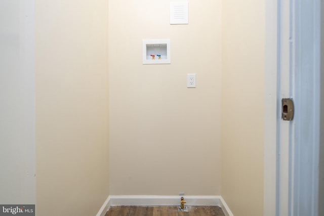 washroom featuring dark wood-type flooring, laundry area, baseboards, and hookup for a washing machine