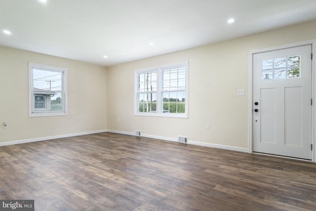 foyer featuring recessed lighting, plenty of natural light, and dark wood-style floors