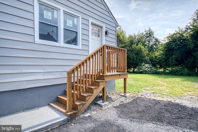 property entrance with a lawn