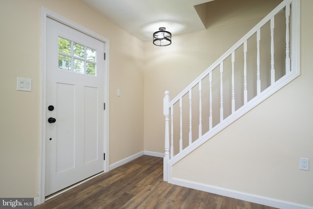 entryway featuring stairs, baseboards, and wood finished floors