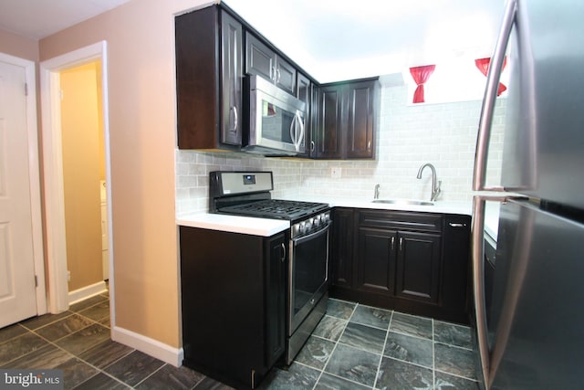 506 S 11th St Unit 33, Philadelphia, PA 19147 - kitchen featuring tasteful backsplash, baseboards, a sink, light countertops, and appliances with stainless steel finishes