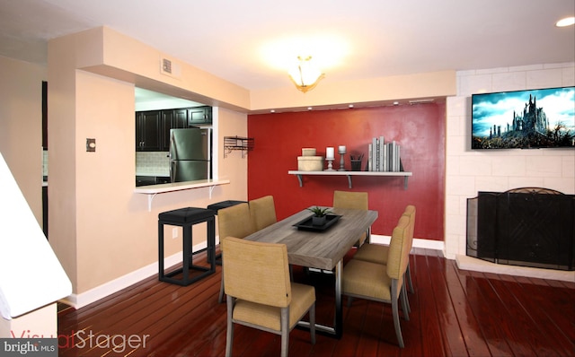 506 S 11th St Unit 33, Philadelphia, PA 19147 - dining space featuring a fireplace, baseboards, visible vents, and hardwood / wood-style flooring