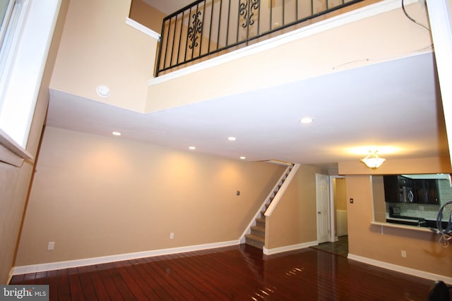 506 S 11th St Unit 33, Philadelphia, PA 19147 - unfurnished living room with recessed lighting, baseboards, hardwood / wood-style flooring, and stairs