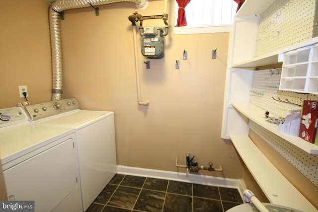 506 S 11th St Unit 33, Philadelphia, PA 19147 - clothes washing area featuring dark tile patterned flooring, laundry area, separate washer and dryer, and baseboards