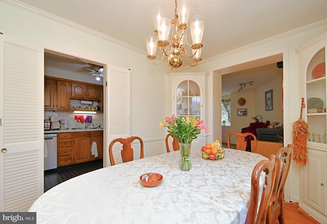 dining space featuring ornamental molding, dark wood-style flooring, and ceiling fan with notable chandelier
