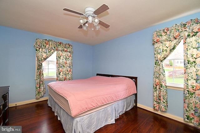 bedroom featuring baseboards, ceiling fan, and wood finished floors