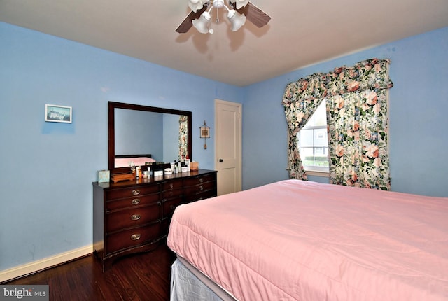 bedroom with baseboards, dark wood finished floors, and ceiling fan