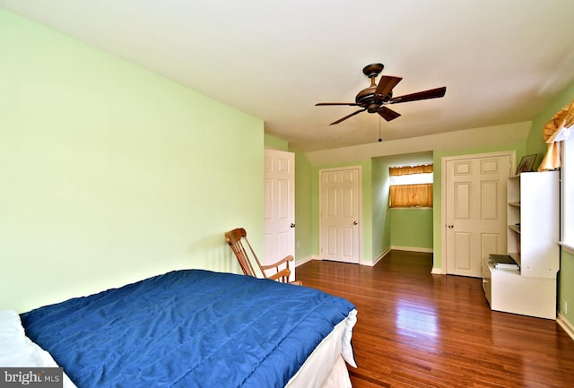 bedroom featuring baseboards, ceiling fan, and wood finished floors