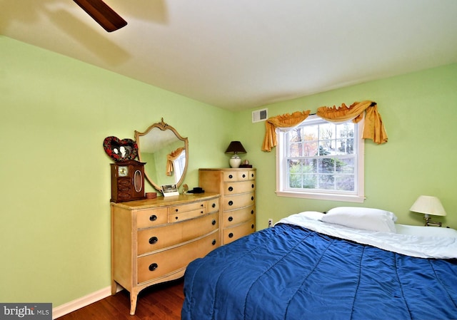bedroom with visible vents, dark wood-style flooring, ceiling fan, and baseboards