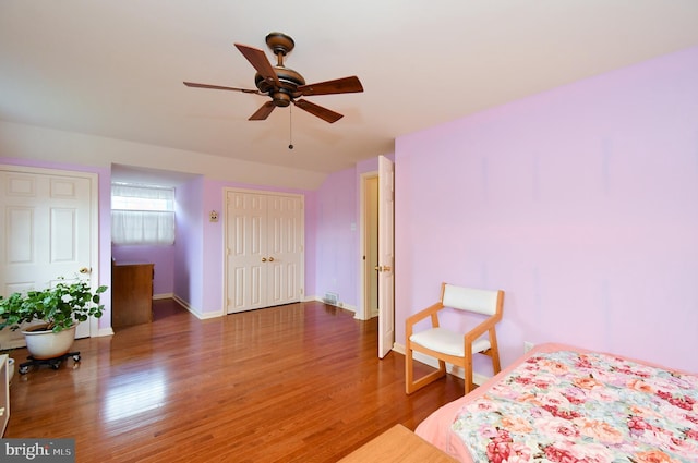 bedroom with baseboards, ceiling fan, and wood finished floors