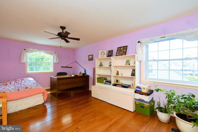 bedroom with baseboards, a ceiling fan, and light wood finished floors