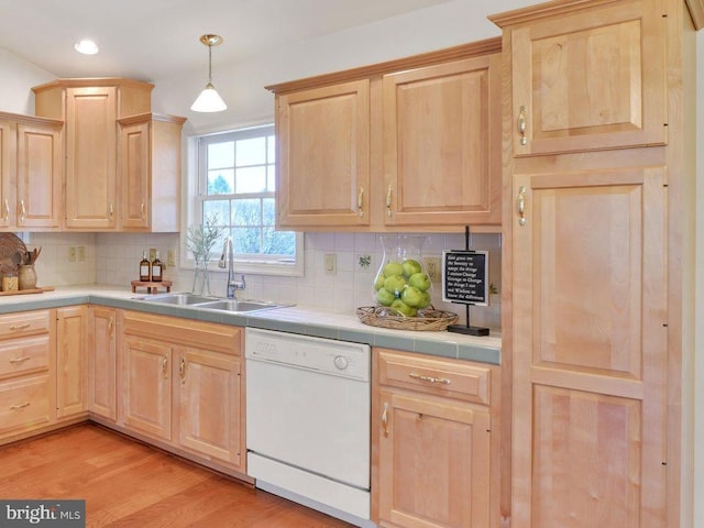 kitchen featuring a sink, light brown cabinetry, and dishwasher